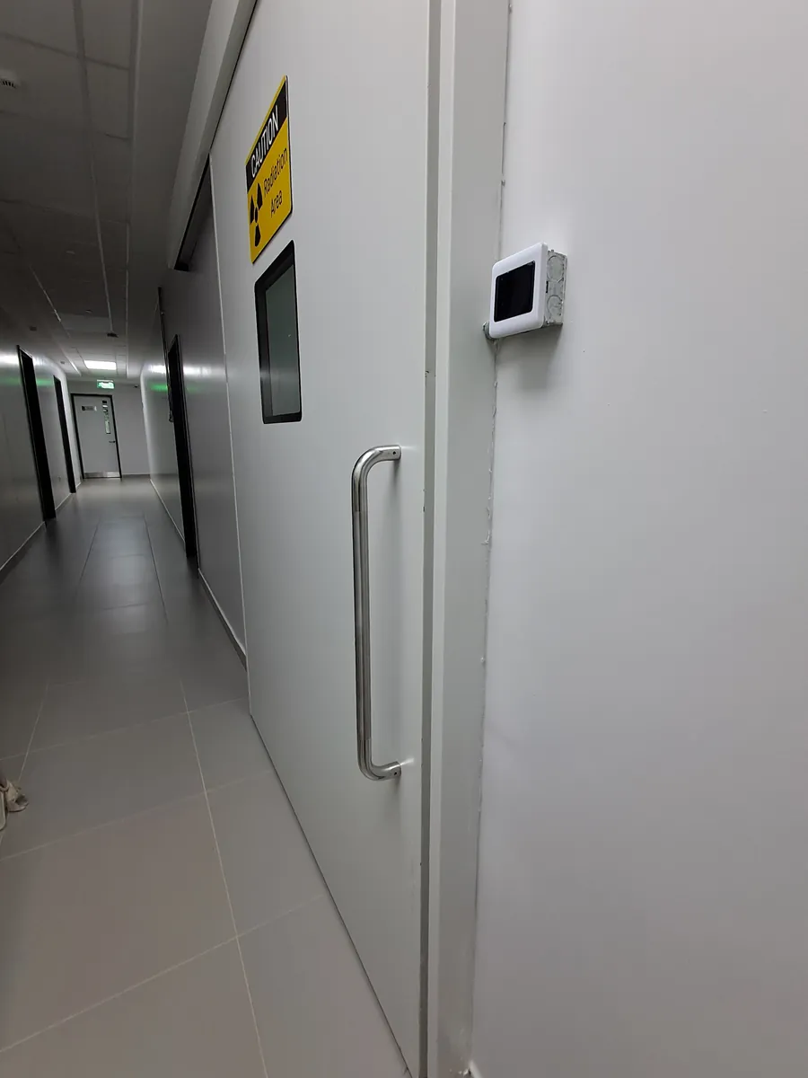 Radiation-shielded lead door installation in imaging corridor