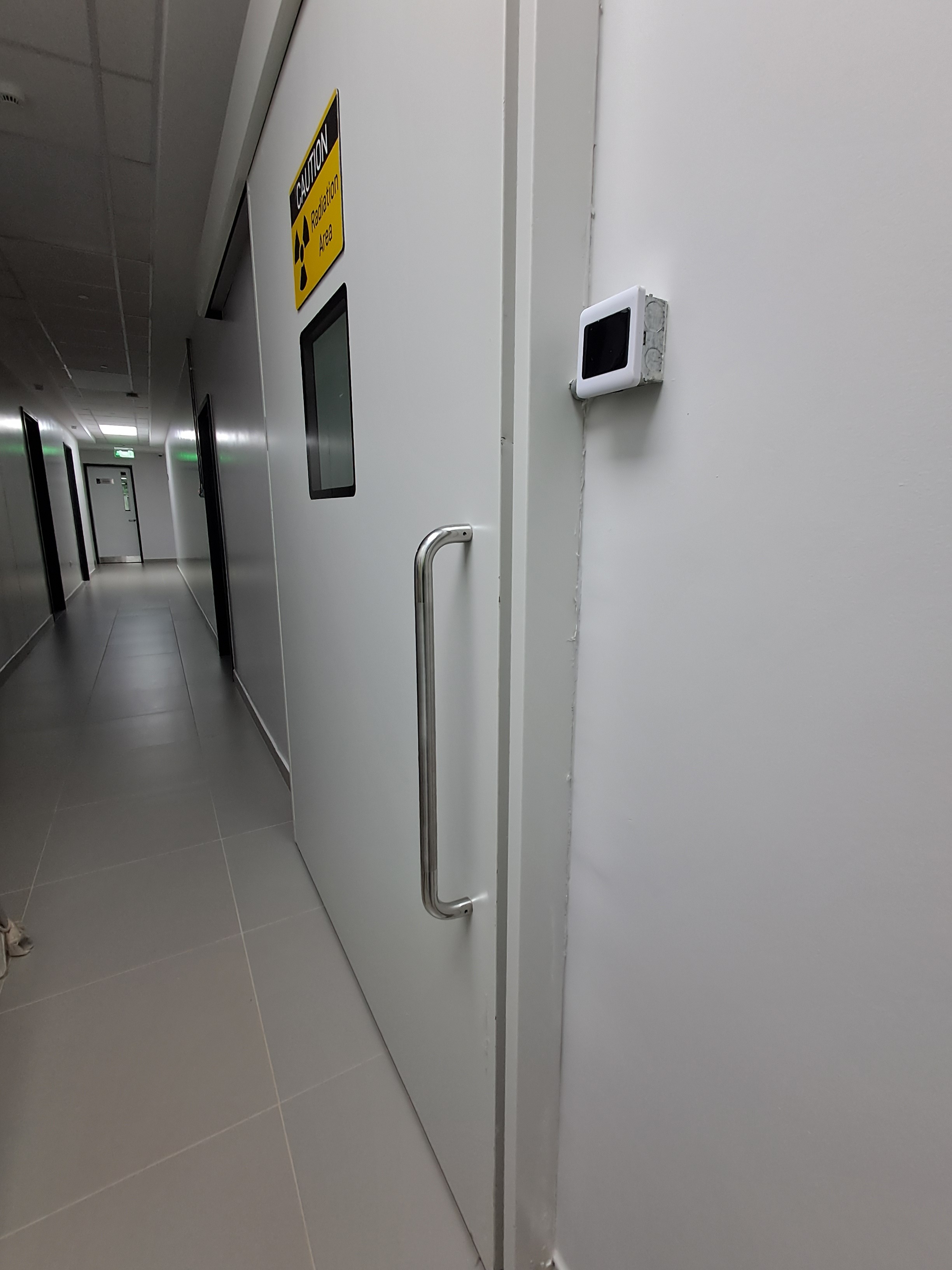 Radiation-shielded lead door installation in imaging corridor